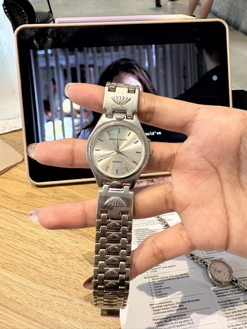 Pierre Mode silver tone quartz wrist watch (Category: Women's Watches) located in Caloocan City. Submitted by esnairahhh (Listing ID 1466440928, Image 1). Description: - Brand: Pierre Mode - Movement: Quartz (battery-operated) - Style: Silver tone with round dial and simple indices - Special Detail: Textured metal link bracelet featuring unique seashell motif accents - Closure: Standard clasp - Condition: Normal wear marks on metal surface from p