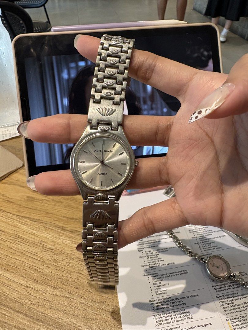 Pierre Mode silver tone quartz wrist watch (Category: Women's Watches) located in Caloocan City. Submitted by esnairahhh (Listing ID 1466440928, Image 2). Description: - Brand: Pierre Mode - Movement: Quartz (battery-operated) - Style: Silver tone with round dial and simple indices - Special Detail: Textured metal link bracelet featuring unique seashell motif accents - Closure: Standard clasp - Condition: Normal wear marks on metal surface from p