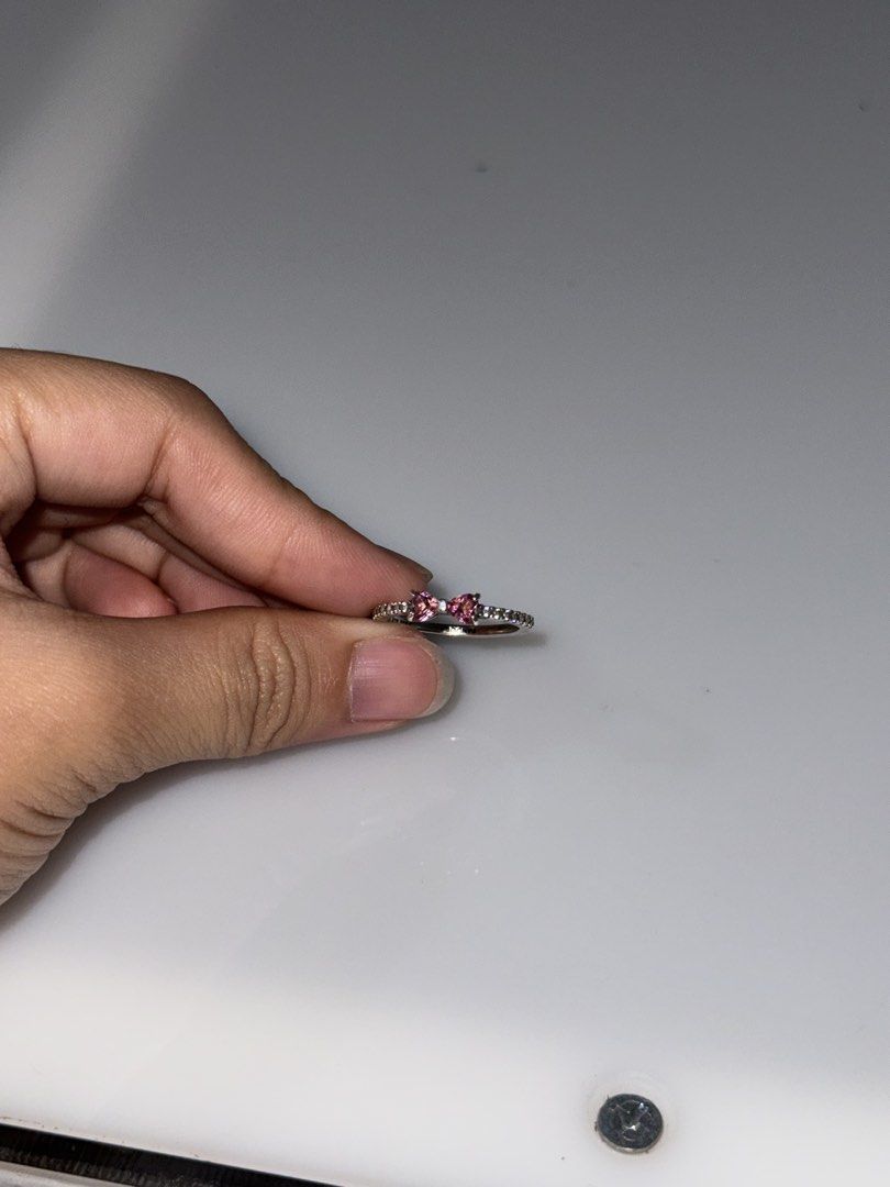 Pink Bow Accent Ring (Category: Rings) located in Baguio. Submitted by pea_chyyy (Listing ID 1466498927, Image 2). Description: - Style: Dainty silver-tone band with a central pink bow - Details: Pave-set small stones around the band - Fit: size 7 - AUTHENTIC WITH BOX .