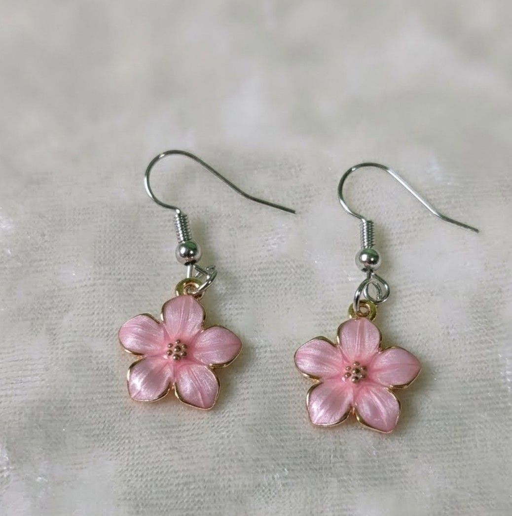 Pink Cherry Blossom Flower Drop Earrings (Category: Earrings) located in Quezon City. Submitted by nouveaucollections (Listing ID 1466443754, Image 1). Description: - Design: Pink cherry blossom enamel flower charms with gold trim and tiny center dots - Style: Light and dainty dangle earrings on silver hooks - Fit: Standard hook closure for pierced ears - Versatility: Perfect everyday accessory for spring and summer.