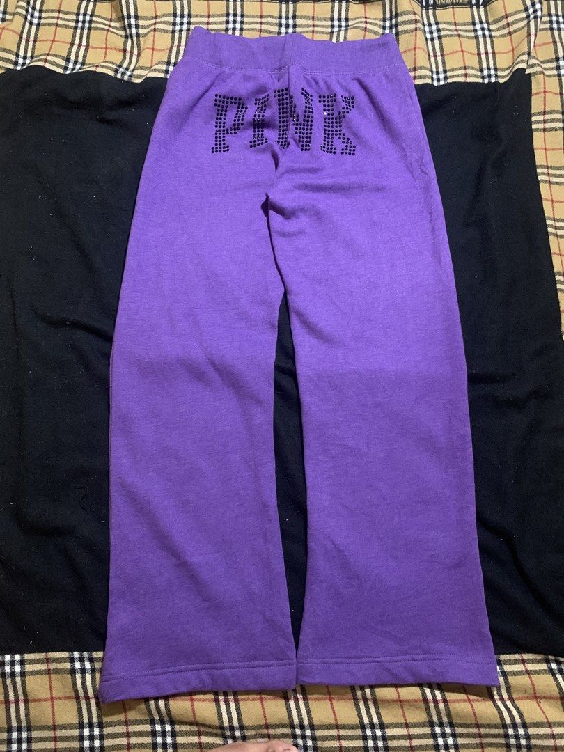 PINK nylon Purple Rhinestone Sweatpants (Category: Jeans) located in Cagayan de Oro. Submitted by chabermz (Listing ID 1466483114, Image 1). Description: - Brand: PINK nylon - Color: Purple - Size: Large - Design: Large rhinestone "PINK" lettering on the back waist and small rhinestone dog logo on the front left hip - Fit: Relaxed flare leg - Interior: Soft, cozy fleece lining - Waistband: Adjustable drawstring with metallic PINK" stamped grommet