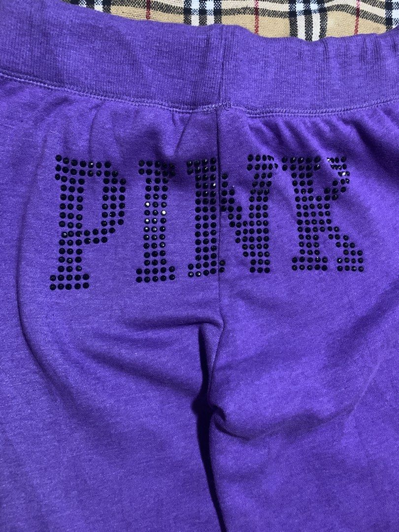 PINK nylon Purple Rhinestone Sweatpants (Category: Jeans) located in Cagayan de Oro. Submitted by chabermz (Listing ID 1466483114, Image 3). Description: - Brand: PINK nylon - Color: Purple - Size: Large - Design: Large rhinestone "PINK" lettering on the back waist and small rhinestone dog logo on the front left hip - Fit: Relaxed flare leg - Interior: Soft, cozy fleece lining - Waistband: Adjustable drawstring with metallic PINK" stamped grommet