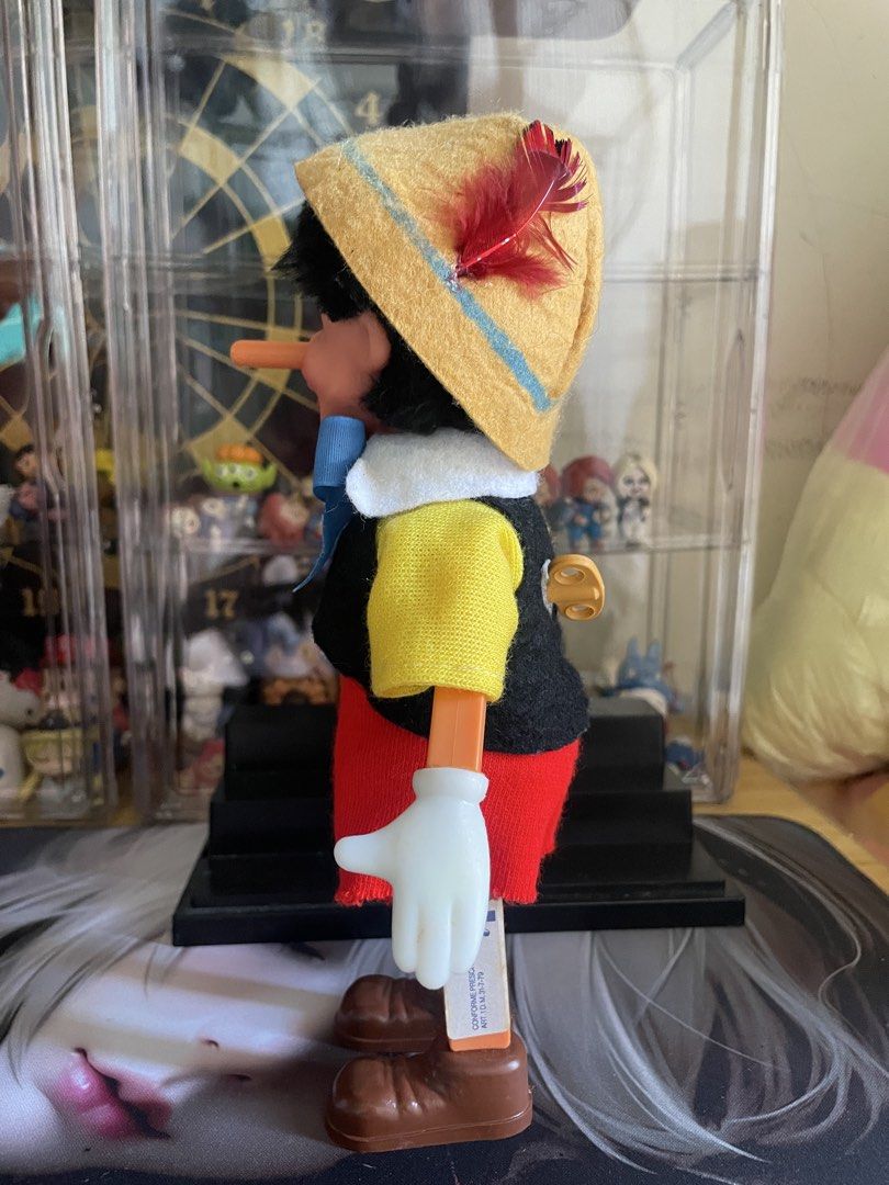 Pinocchio Wind-Up Doll with Hat and Bow (Category: Plushies & Soft Toys) located in Agdangan. Submitted by kuradekawaii_06 (Listing ID 1466561927, Image 2). Description: - WIND UP WORKING - Features iconic details: blue bow tie, yellow hat with red feather, and a wind-up key on the back - Dressed in a yellow shirt, black vest, red shorts, white gloves, and brown shoes - Made with clean fabric clothes and well-painted plastic parts.