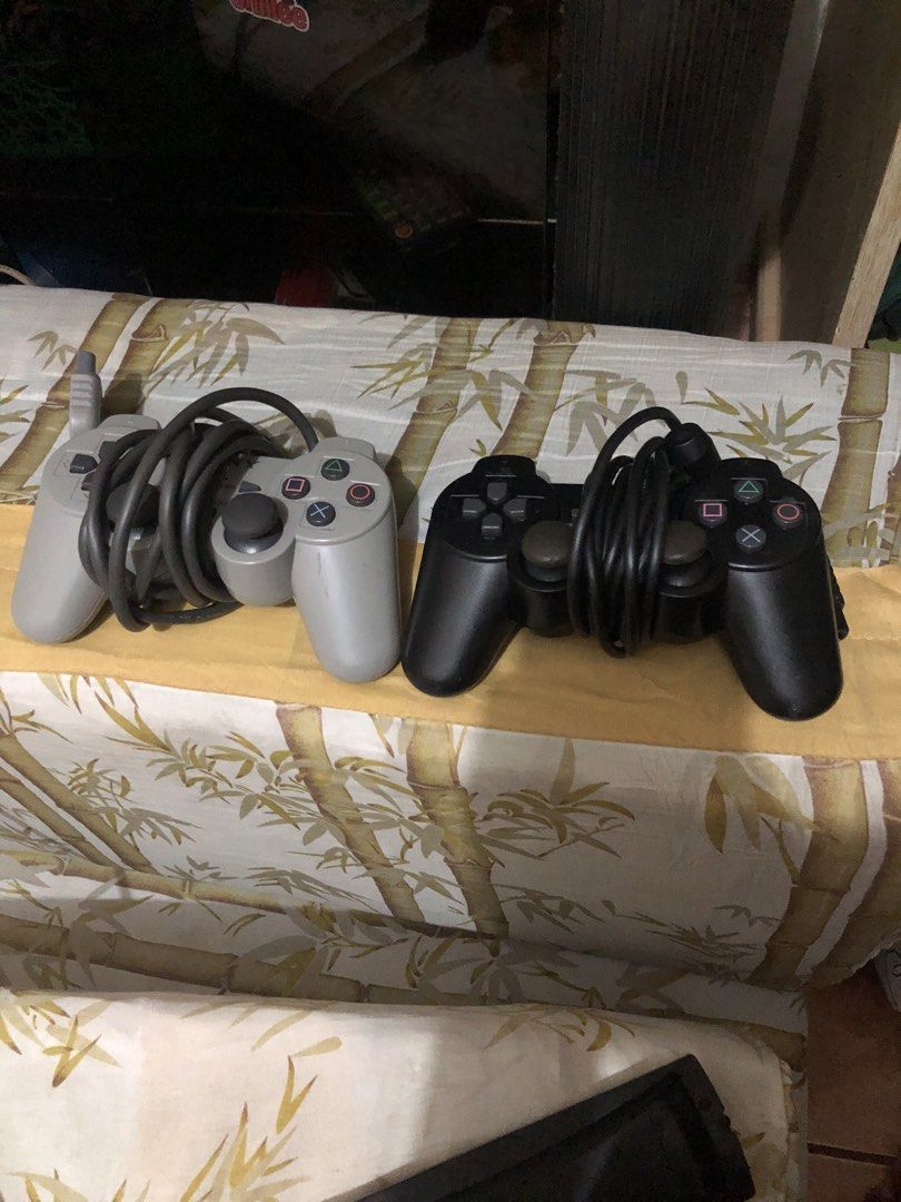 PlayStation 2 Console with Controllers and Memory Cards (Category: PlayStation) located in Manila. Submitted by warmstone_3189cf (Listing ID 1466338460, Image 2). Description: Sony PlayStation 2 console bundled with two wired controllers, one grey and one black. Includes two memory cards, an 8MB Hori MagicGate card and a standard grey memory card. Console turns on, tested up to the browser menu screen as pictured. Standard wear on controllers and
