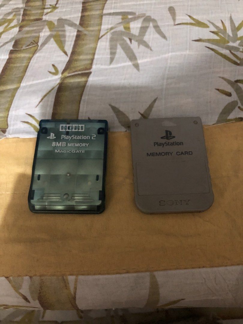 PlayStation 2 Console with Controllers and Memory Cards (Category: PlayStation) located in Manila. Submitted by warmstone_3189cf (Listing ID 1466338460, Image 1). Description: Sony PlayStation 2 console bundled with two wired controllers, one grey and one black. Includes two memory cards, an 8MB Hori MagicGate card and a standard grey memory card. Console turns on, tested up to the browser menu screen as pictured. Standard wear on controllers and