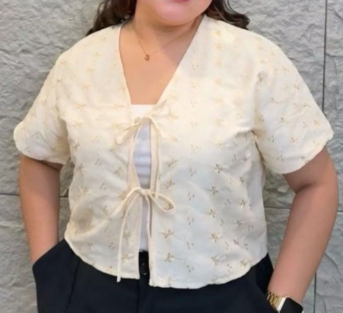 Plus size floral eyelet tie-front crop top (Category: Blouses) located in Manila. Submitted by cassandruhh (Listing ID 1466464738, Image 1). Description: - Inner not included - Color: Cream - Style: Short sleeve, cropped fit, V-neck with double ribbon ties - Detail: All-over floral eyelet embroidery - Condition: Brand new never worn .