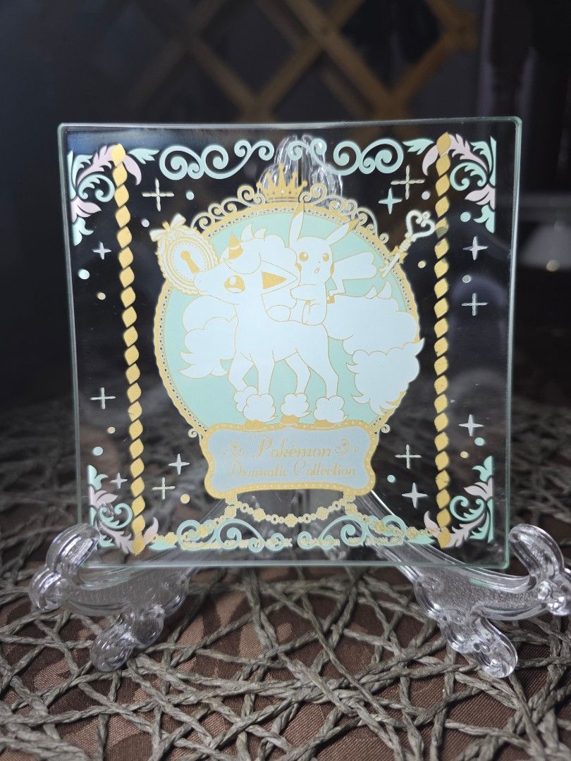 Pokemon Dramatic Collection Glass Plate (Category: Dinnerware & Cutlery) located in Zamboanga. Submitted by lunavinum (Listing ID 1466563482, Image 1). Description: -Pikachu & Galarian Ponyta Pokémon Glass Plate Approx meas: 4.3" x 4.3" Condition: Lightly used - Official Nintendo merchandise from the Pokémon Dramatic Collection - Features a stunning graphic of Pikachu and Ninetales inside an ornate circular frame - Beautiful pastel green backgrou