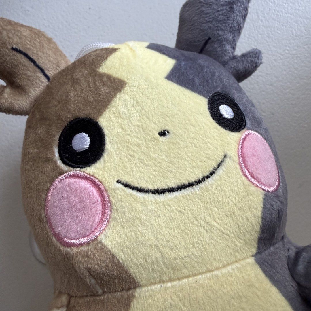 Pokémon Pikachu Plush Toy with Suction Cup (Category: Plushies & Soft Toys) located in Manila. Submitted by cheemkenn (Listing ID 1466430889, Image 2). Description: - Official Pokémon merchandise with tag still attached - Unique asymmetric brown and grey color blocking design - Features cute embroidered facial details and pink cheeks - Comes with a hanging string and clear suction cup for easy window mounting - Perfect gift for Pokémon fans and c