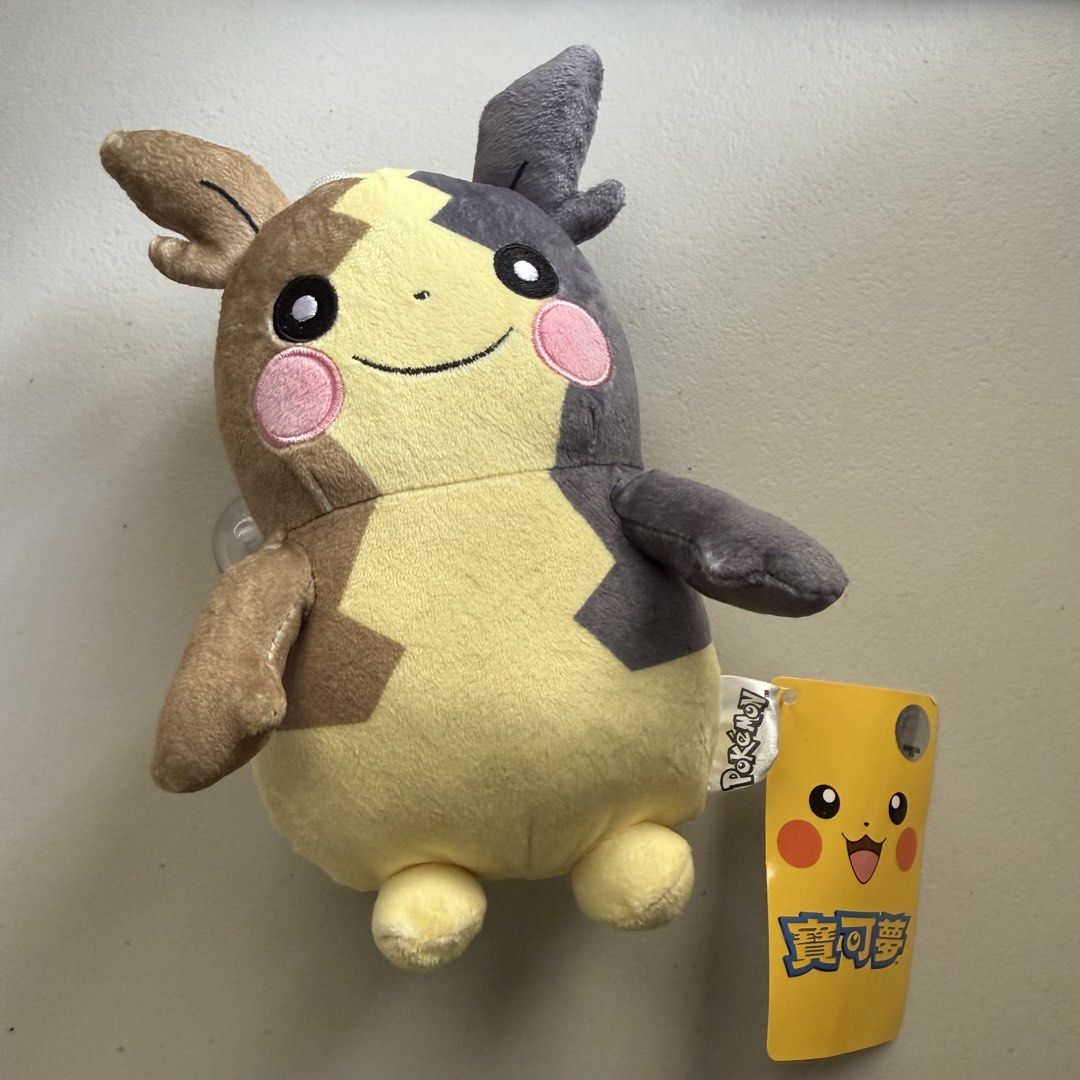 Pokémon Pikachu Plush Toy with Suction Cup (Category: Plushies & Soft Toys) located in Manila. Submitted by cheemkenn (Listing ID 1466430889, Image 1). Description: - Official Pokémon merchandise with tag still attached - Unique asymmetric brown and grey color blocking design - Features cute embroidered facial details and pink cheeks - Comes with a hanging string and clear suction cup for easy window mounting - Perfect gift for Pokémon fans and c