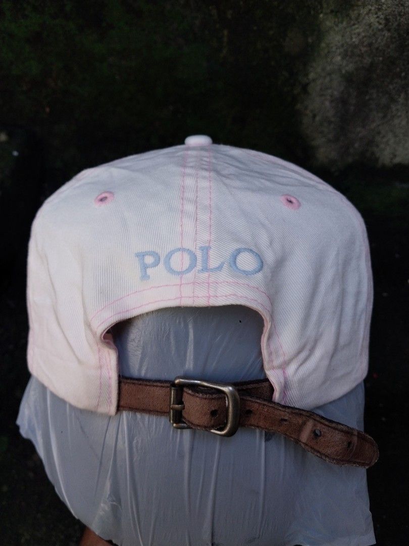 Polo by Ralph Lauren Pink Cap Hat (Category: Caps & Hats) located in Sorsogon. Submitted by Gthrift420 (Listing ID 1466450168, Image 3). Description: - Brand: Polo by Ralph Lauren - Color: Light pink with light blue embroidery and pink contrast stitching - Material: 100% cotton, Made in Taiwan - Design: Embroidered polo player on front, number three on side, and polo text on back - Fit: Adjustable brown leather strap with metal buckle - Condition