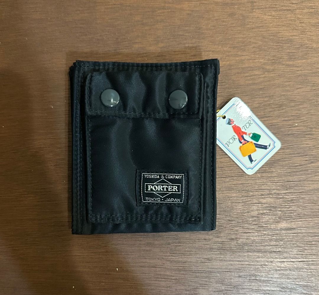 Porter Tanker Wallet Black Yoshida & Co (Category: Luxury Bags & Wallets) located in San Juan City. Submitted by looneyc (Listing ID 1466399126, Image 1). Description: - Brand: Yoshida & Co. Porter (Tanker Series) - Material: Durable black nylon - Condition: Brand new with original tag attached - Origin: Made in Japan - Exterior: Dual snap pockets on the front - Interior: Card slots, zippered coin pouch, and attached key ring with signature orang