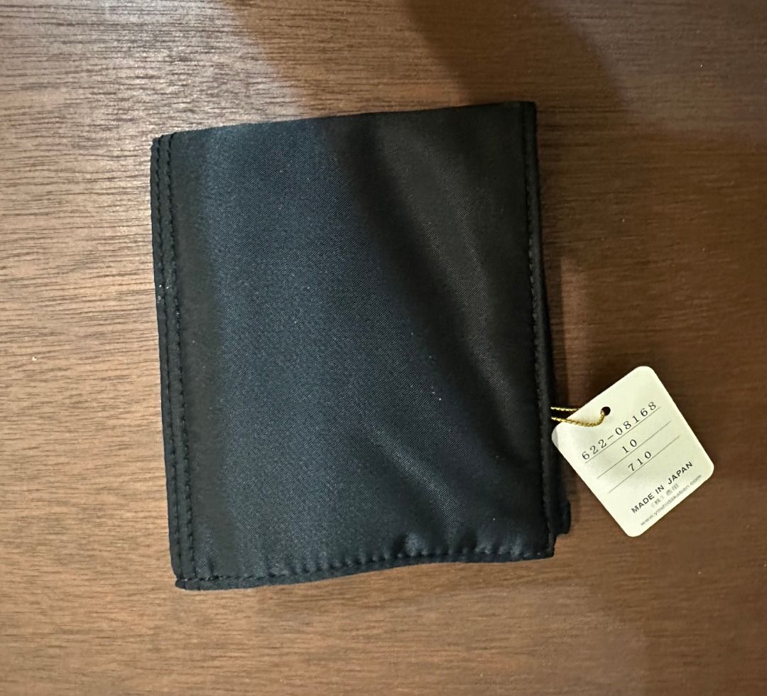 Porter Tanker Wallet Black Yoshida & Co (Category: Luxury Bags & Wallets) located in San Juan City. Submitted by looneyc (Listing ID 1466399126, Image 3). Description: - Brand: Yoshida & Co. Porter (Tanker Series) - Material: Durable black nylon - Condition: Brand new with original tag attached - Origin: Made in Japan - Exterior: Dual snap pockets on the front - Interior: Card slots, zippered coin pouch, and attached key ring with signature orang