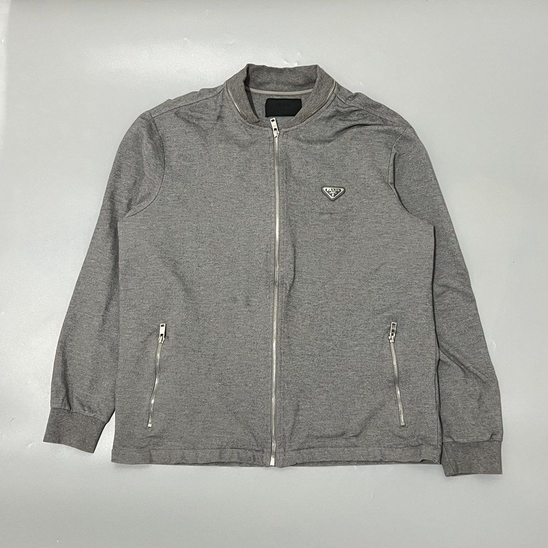 Prada - Bomber Jacket - Zip Up (Category: Coats, Jackets and Outerwear) located in Cavite. Submitted by asianluxe (Listing ID 1466441758, Image 1). Description: PRADA - Bomber Jacket - Zip Up Flat measurements! Size:XL Length:28 inches Armpit to armpit:24 inches Sleeve:25 inches Shoulder to shoulder:19 inches Good condition Very presentable No flaw or damage.