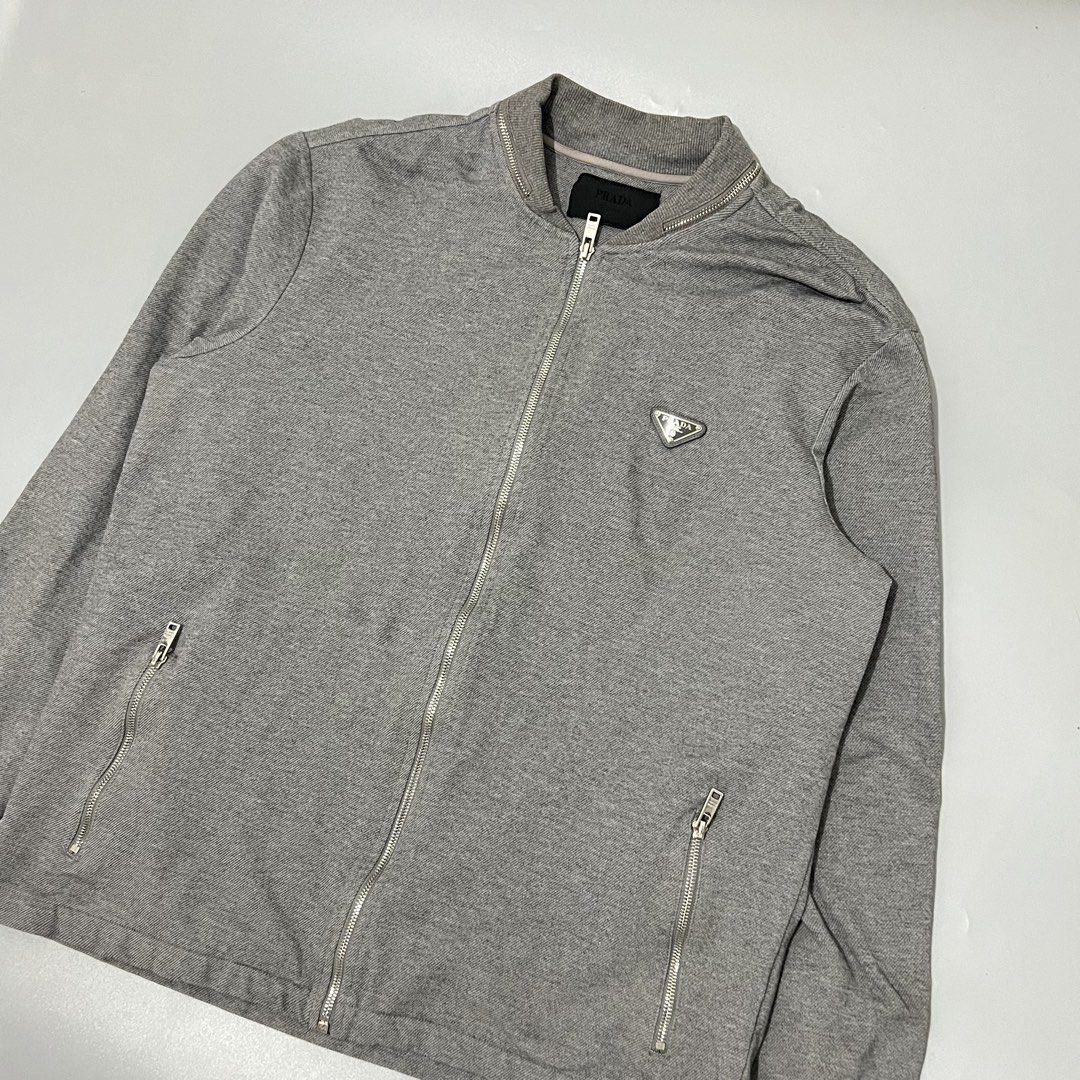 Prada - Bomber Jacket - Zip Up (Category: Coats, Jackets and Outerwear) located in Cavite. Submitted by asianluxe (Listing ID 1466441758, Image 2). Description: PRADA - Bomber Jacket - Zip Up Flat measurements! Size:XL Length:28 inches Armpit to armpit:24 inches Sleeve:25 inches Shoulder to shoulder:19 inches Good condition Very presentable No flaw or damage.
