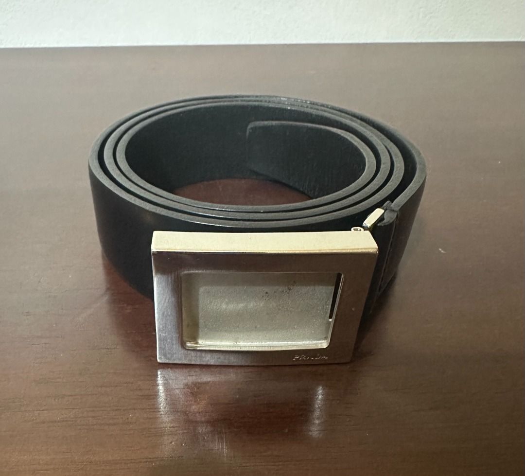 Prada Black Leather Belt with Silver Buckle (Category: Belts) located in San Juan City. Submitted by looneyc (Listing ID 1466397555, Image 1). Description: - Brand: Prada - Material: Genuine black leather - Hardware: Polished silver-tone rectangular buckle with engraved branding - Style: Versatile, suitable for both casual and formal outfits Slight leather crease but flattens/stretches out so not visible when worn. Prada Men's Back Leather Belt w