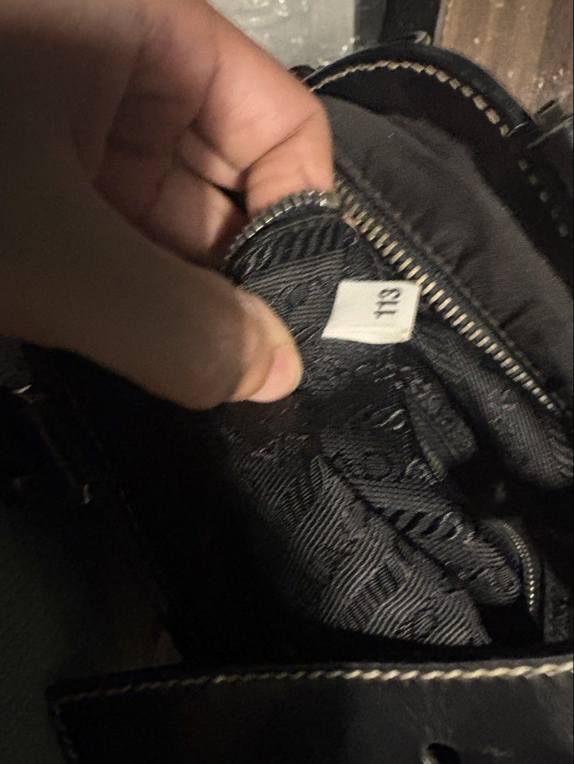 Prada Black Nylon Leather Trimmed Shoulder Bag (Category: Luxury Bags & Wallets) located in Quezon City. Submitted by mileena3 (Listing ID 1464234175, Image 3). Description: - Authentic Black Prada Shoulder Bag - Durable Nylon Body with Leather Trim - Elegant Leather Handles - Silver Hardware Details - Secure Zipper Closure with Lock and Key - Classic and Versatile Design - Ideal for Everyday Use.