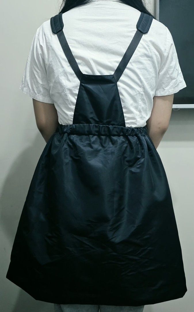 Prada Black Nylon Mini Camisole Dress (Category: Dresses) located in Manila. Submitted by ubasirene (Listing ID 1466375992, Image 3). Description: - Designer camisole dress by Prada, made in Romania - Color: Classic black - Material: 100% polyamide outer with 100% viscose lining - Design: Stylish cowl neck, dropped waistline, and adjustable shoulder straps - Features: Front zipper pocket accented with the iconic Prada metal logo triangle - Fit: E