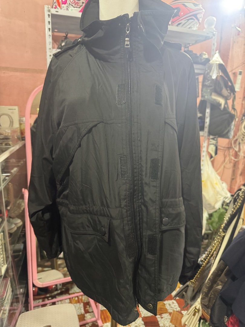 Prada Milano Black Windbreaker Jacket with Hood (Category: Coats, Jackets and Outerwear) located in Manila. Submitted by wildbear.e10374 (Listing ID 1466426394, Image 2). Description: - Brand: Prada Milano - Color: Classic black - Material: Smooth, weather-resistant nylon - Closure: Full zip with snap buttons - Features: High collar with adjustable hood, drawstring waist, and front pockets with button flaps - Details: Branded hardware on zippers 