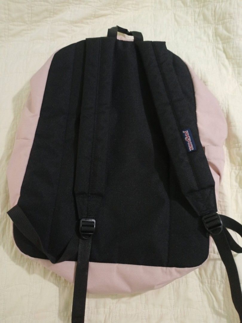 Pre-loved JanSport SuperBreak Backpack (Misty Rose, 26L) (Category: Backpacks) located in Baguio. Submitted by coffee.bins.grounds (Listing ID 1466408335, Image 2). Description: Product Details & Features: Capacity: 26 Liters Color: Misty Rose (Soft Pastel Pink) Material: 600D Durable Fabric Features: 1 large main compartment, front utility pocket with organizer, side water bottle pocket, padded shoulder straps, and padded back panel. Condition: 