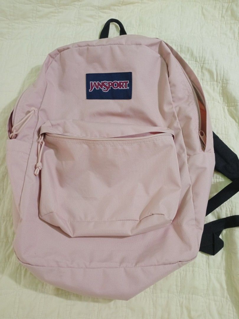 Pre-loved JanSport SuperBreak Backpack (Misty Rose, 26L) (Category: Backpacks) located in Baguio. Submitted by coffee.bins.grounds (Listing ID 1466408335, Image 1). Description: Product Details & Features: Capacity: 26 Liters Color: Misty Rose (Soft Pastel Pink) Material: 600D Durable Fabric Features: 1 large main compartment, front utility pocket with organizer, side water bottle pocket, padded shoulder straps, and padded back panel. Condition: 
