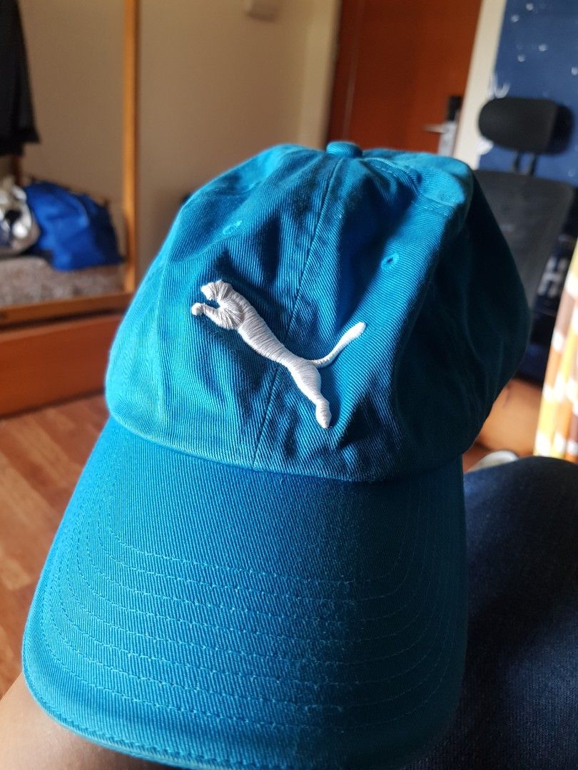Puma Blue Cap with White Embroidered Logo (Category: Caps & Hats) located in Manila. Submitted by anthonylee23810 (Listing ID 1466449332, Image 1). Description: - Brand: Puma - Color: Bright blue with white embroidered cat logo - Material: 100% cotton - Size: Adjustable strap for a custom fit - Style Number: 83240 - Condition: Clean fabric with no major wear.