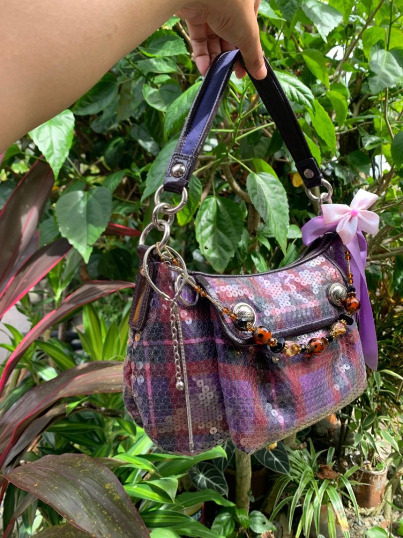Purple Plaid Sequin Handbag with Ribbon (Category: Shoulder Bags) located in Piddig. Submitted by yhanshop (Listing ID 1466394830, Image 2). Description: - Style: Unique Y2K sparkle handbag in a purple and red plaid sequin design - Accents: Decorated with a beaded charm chain and a cute light purple side bow - Structure: Features a single dark top handle and maintains a clean, sturdy shape - Condition: Clean fabric with good structure, ready to w