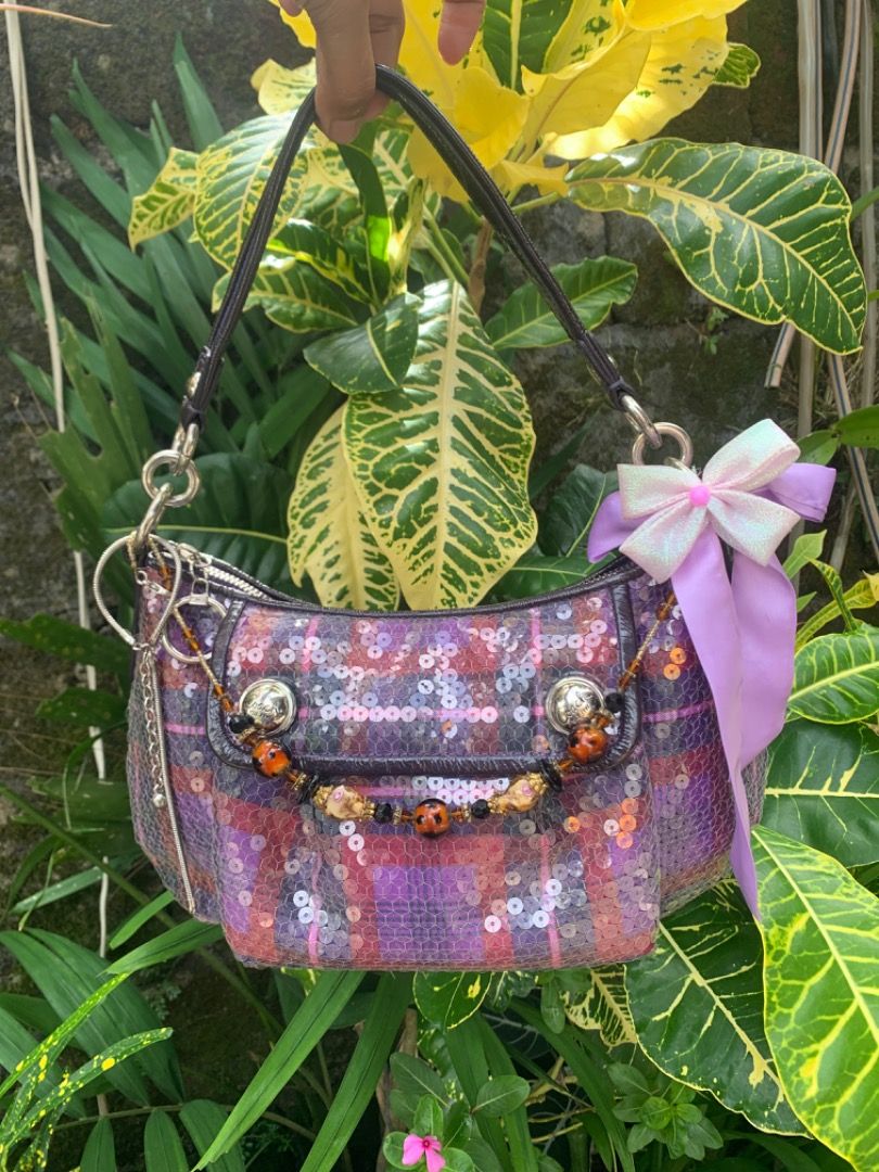 Purple Plaid Sequin Handbag with Ribbon (Category: Shoulder Bags) located in Piddig. Submitted by yhanshop (Listing ID 1466394830, Image 3). Description: - Style: Unique Y2K sparkle handbag in a purple and red plaid sequin design - Accents: Decorated with a beaded charm chain and a cute light purple side bow - Structure: Features a single dark top handle and maintains a clean, sturdy shape - Condition: Clean fabric with good structure, ready to w