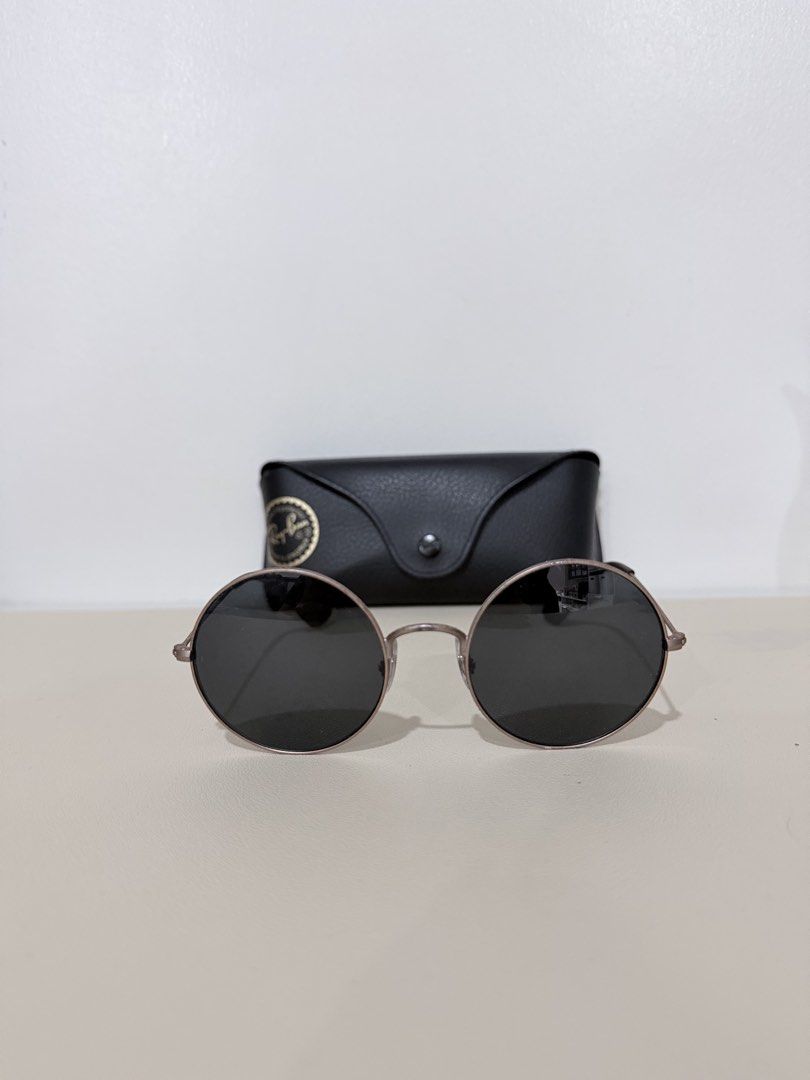Ray-Ban Round Metal Sunglasses with Case (Category: Sunglasses & Eyewear) located in Manila. Submitted by prelovedbymycam (Listing ID 1466350520, Image 1). Description: - Brand: Ray-Ban - Style: Round metal sunglasses with thin gold-tone frames and dark lenses - Details: Dark brown temple tips, classic everyday style - Inclusion: Original black leatherette hard case with Ray-Ban logo stamp.