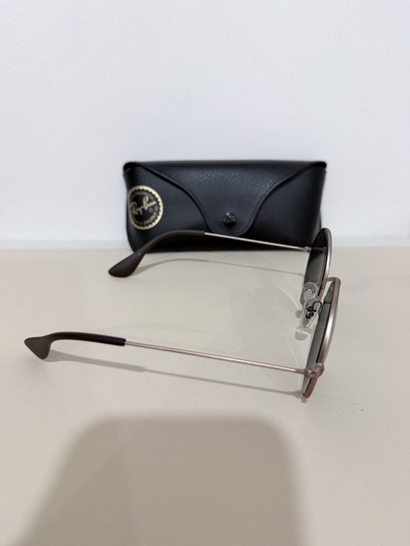 Ray-Ban Round Metal Sunglasses with Case (Category: Sunglasses & Eyewear) located in Manila. Submitted by prelovedbymycam (Listing ID 1466350520, Image 2). Description: - Brand: Ray-Ban - Style: Round metal sunglasses with thin gold-tone frames and dark lenses - Details: Dark brown temple tips, classic everyday style - Inclusion: Original black leatherette hard case with Ray-Ban logo stamp.