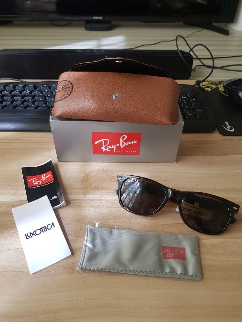 Ray-Ban Sunglasses with Case and Accessories (Category: Sunglasses & Eyewear) located in Manila. Submitted by anthonylee23810 (Listing ID 1466449016, Image 2). Description: - Authentic Ray-Ban sunglasses featuring stylish tortoise-shell frames and dark lenses - Complete full-set inclusion: original grey storage box and brown leather-look snap-button case - Includes brand-new grey cleaning cloth still sealed in plastic - Comes with official Luxott