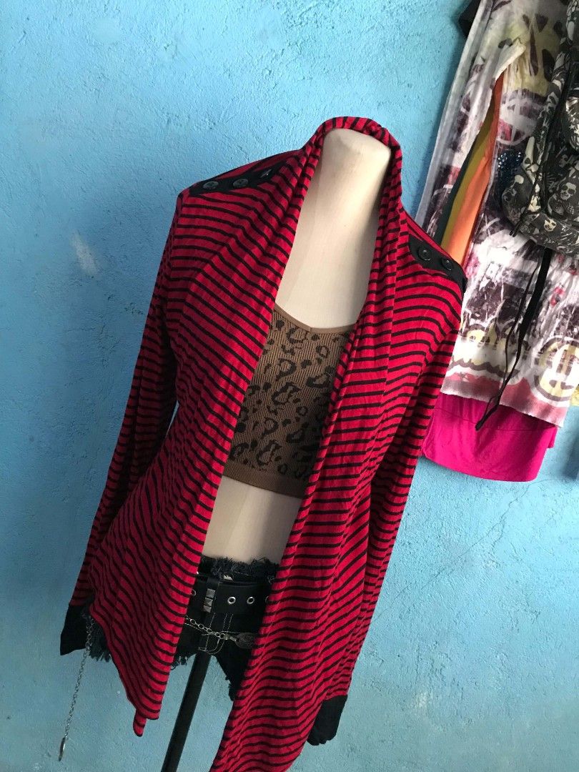 Red and Black Striped Cardigan (Category: Coats, Jackets and Outerwear) located in Alaminos. Submitted by elysian_thrifts (Listing ID 1466506775, Image 2). Description: - Color/Pattern: Red and black stripes - Material: Lightweight and easy to layer - Design: Open front with a stylish waterfall hemline - Details: Contrasting black shoulder patches and cuffs - Style: Long sleeves, perfect for adding a pop of color to casual looks.