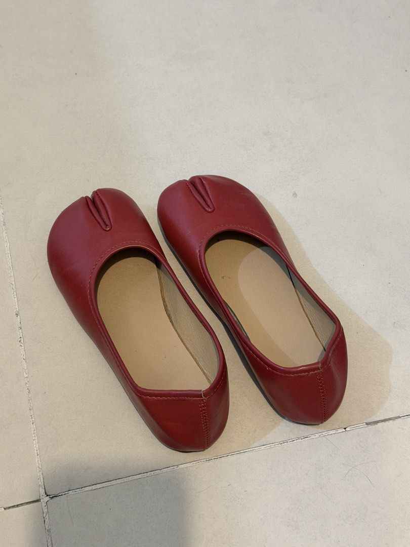 Red split toe tabi flats (Category: Flats & Sandals) located in Taguig. Submitted by mengxir20193848 (Listing ID 1466525121, Image 2). Description: - Style: Trendy split-toe tabi slip-on flats - Color: Bright red leather-look material with stylish contrast stitching - Interior: Soft tan inner lining for added comfort - Design: Minimalist flat sole, perfect for easy daily wear - Condition: Brand new / Excellent quality.