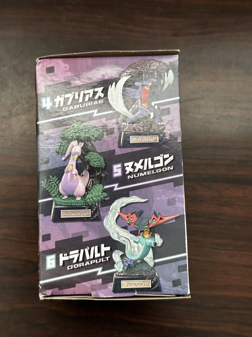 Re-Ment Pokémon Pocket Statue Dragon Type Dragapult (Category: Figurines & Statues) located in Cavite. Submitted by debbieafrica (Listing ID 1466431385, Image 2). Description: - Brand: Re-Ment Pokémon Pocket Statue - Series: Dragon Type (Box #4 - Garchomp) - Condition: Brand new, unopened blind box - Features detailed Garchomp figure inside - Outer box shows full 6-figure collection (Dragonite, Flygon, Salamence, Goodra, Dragapult, Garchomp) - 10