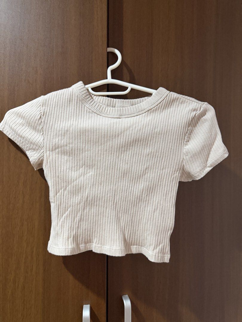 Ribbed Short Sleeve Crop Top Beige (Category: Shirts) located in Cebu City. Submitted by prelovedbymecebu (Listing ID 1466337103, Image 1). Description: - Color: Beige - Material: Stretchy ribbed knit - Fit: Snug, cropped length - Details: Classic round neckline, short sleeves - Condition: Clean and well-maintained - Styling: Great basic piece for high-waisted jeans or skirts.