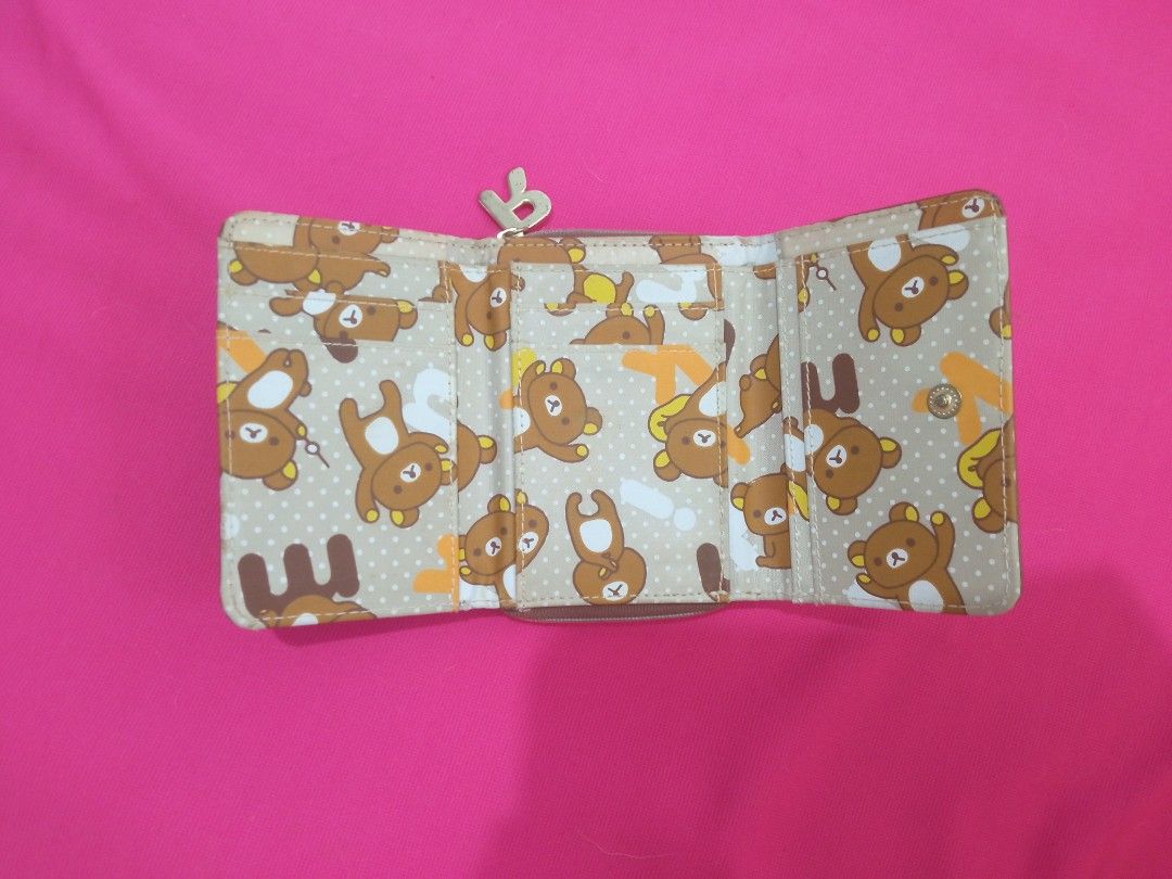 Rilakkuma Small Trifold Wallet from JAPAN (Category: Wallets & Card holders) located in Batangas. Submitted by buddy_and_willow (Listing ID 1466413761, Image 3). Description: ‼️PLEASE READ FULL DESCRIPTION and SEE ALL PHOTOS‼️ Preloved from JAPAN. Small trifold wallet. Combination of canvas and leather materials on the outside. Colored Rilakkuma pattern printed all over the inner lining. Separate zipper dual coin compartment with a letter R gold 
