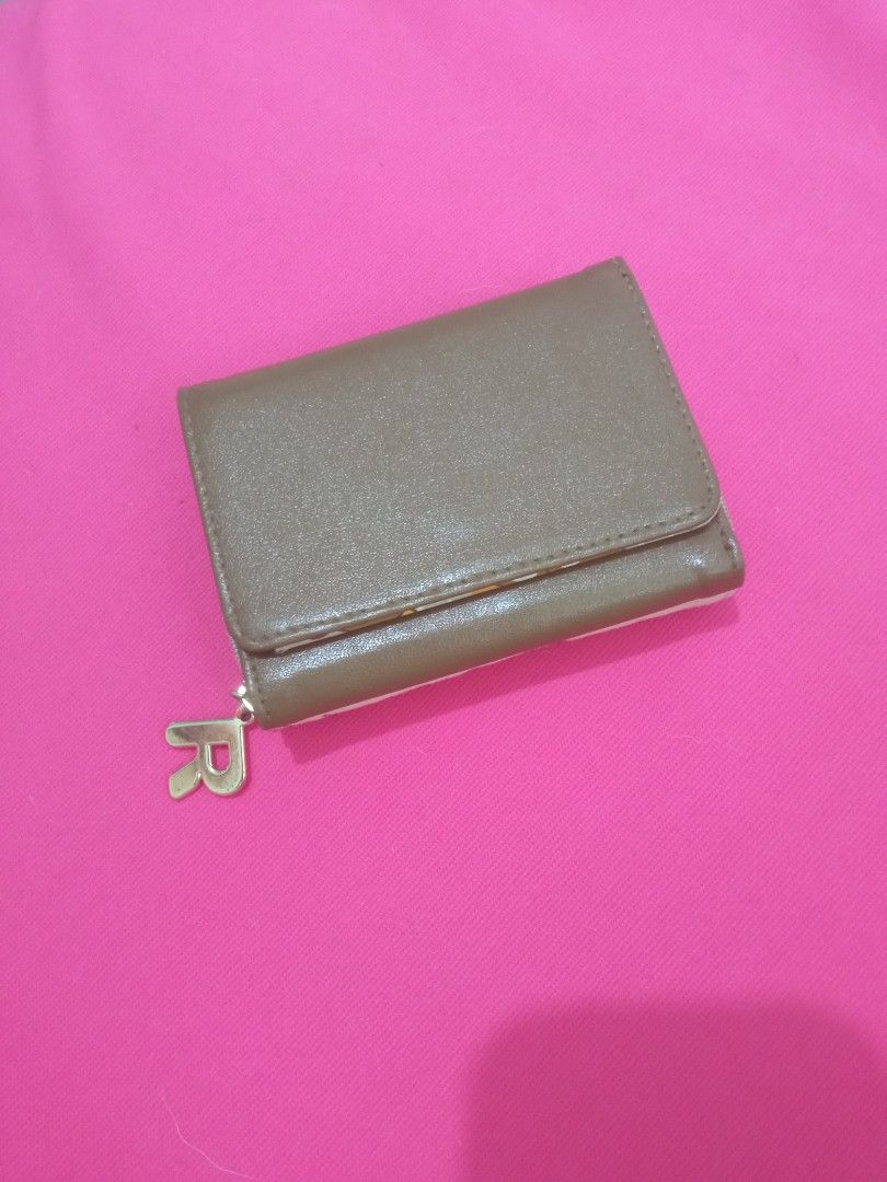 Rilakkuma Small Trifold Wallet from JAPAN (Category: Wallets & Card holders) located in Batangas. Submitted by buddy_and_willow (Listing ID 1466413761, Image 2). Description: ‼️PLEASE READ FULL DESCRIPTION and SEE ALL PHOTOS‼️ Preloved from JAPAN. Small trifold wallet. Combination of canvas and leather materials on the outside. Colored Rilakkuma pattern printed all over the inner lining. Separate zipper dual coin compartment with a letter R gold 