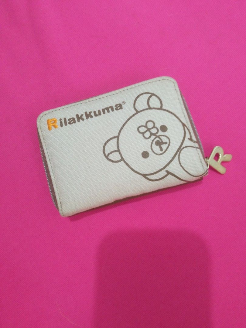 Rilakkuma Small Trifold Wallet from JAPAN (Category: Wallets & Card holders) located in Batangas. Submitted by buddy_and_willow (Listing ID 1466413761, Image 1). Description: ‼️PLEASE READ FULL DESCRIPTION and SEE ALL PHOTOS‼️ Preloved from JAPAN. Small trifold wallet. Combination of canvas and leather materials on the outside. Colored Rilakkuma pattern printed all over the inner lining. Separate zipper dual coin compartment with a letter R gold 
