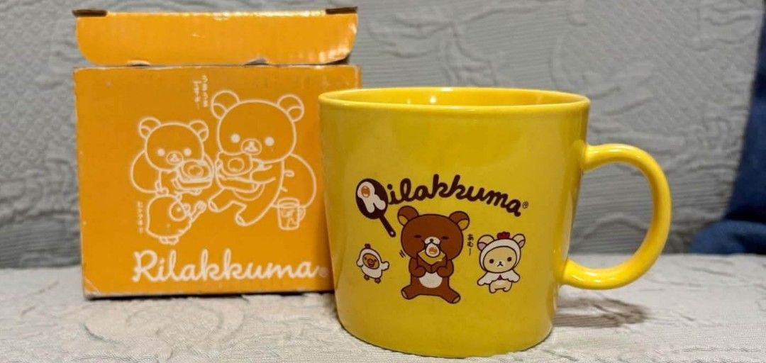 Rilakkuma Yellow Ceramic Mug with Original Box (Category: Coffee & Tea Tableware) located in Quezon City. Submitted by peachhalves (Listing ID 1466417852, Image 1). Description: Please comment or PM me if you are interested or want more close-up photos. Thank you!#rilakkuma #korilakkuma#rilakkumalover#rilakkumamug - Authentic Rilakkuma ceramic mug in bright yellow - Comes with a matching orange storage box featuring cute character graphics - Stan