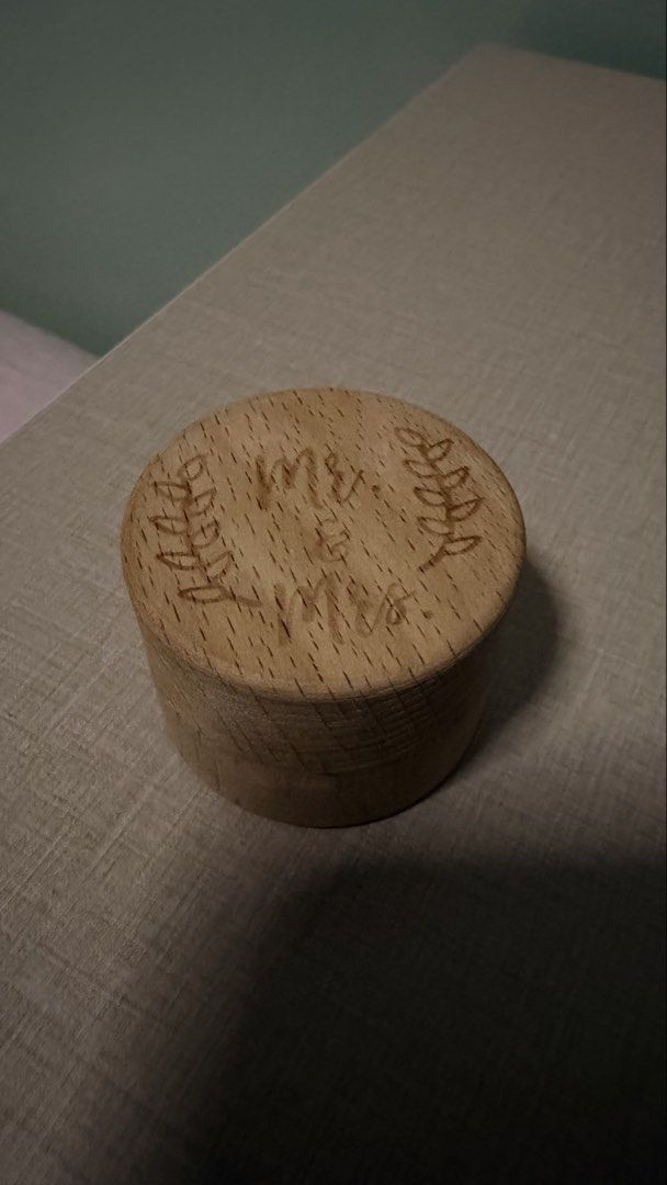 Rustic Mr & Mrs Engraved Wooden Ring Box (Category: Accessory Holder, Box & Organizers) located in Cebu City. Submitted by eynjlin (Listing ID 1466493066, Image 1). Description: Round wooden box with lid. Engraved 'Mr. & Mrs.' text on top flanked by leaf wreaths. Natural wood grain finish. Compact size for holding wedding bands or small trinkets. Smooth surface, lightweight construction..