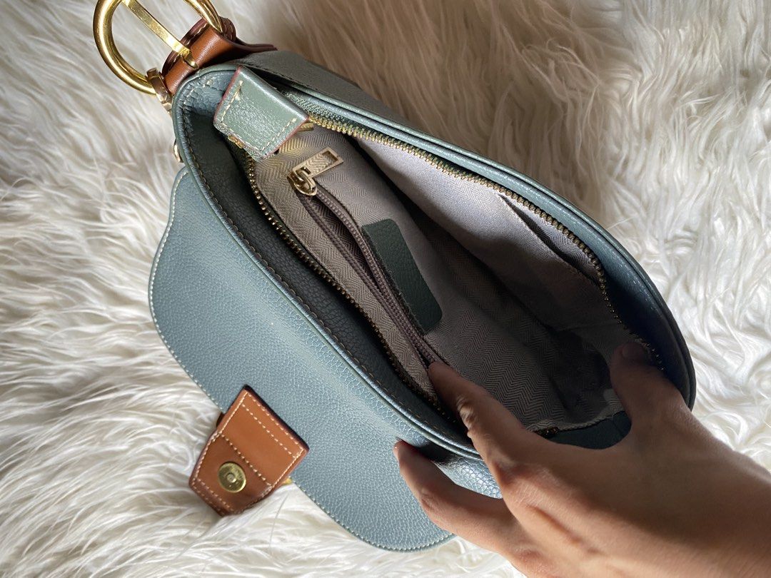Sage Green and Brown Leather Shoulder Bag (Category: Shoulder Bags) located in Manila. Submitted by kimberlyma95836 (Listing ID 1466413097, Image 3). Description: - Color/Material: Sage green pebbled leather with brown leather accents - Hardware: Gold-toned - Closure: Front flap with decorative buckle and magnetic snap - Handle: Short detachable handle - Interior: Fabric-lined with a zippered pocket and slip pockets - Condition: Great everyday ac