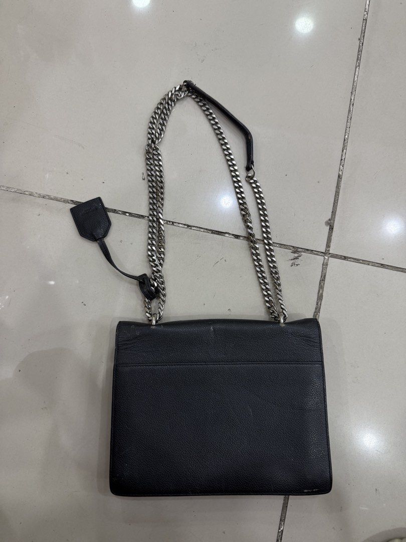 Saint Laurent College Monogram Chain Bag Black (Category: Luxury Bags & Wallets) located in Bacolod City. Submitted by kitcarsonduff (Listing ID 1466487158, Image 2). Description: - Brand: Saint Laurent (YSL) - Style: College Monogram Shoulder Bag - Material: Black grained leather - Hardware: Silver-toned with signature YSL interlocking logo - Features: Chain strap with leather shoulder guard, rear exterior slip pocket, and secure magnetic closur