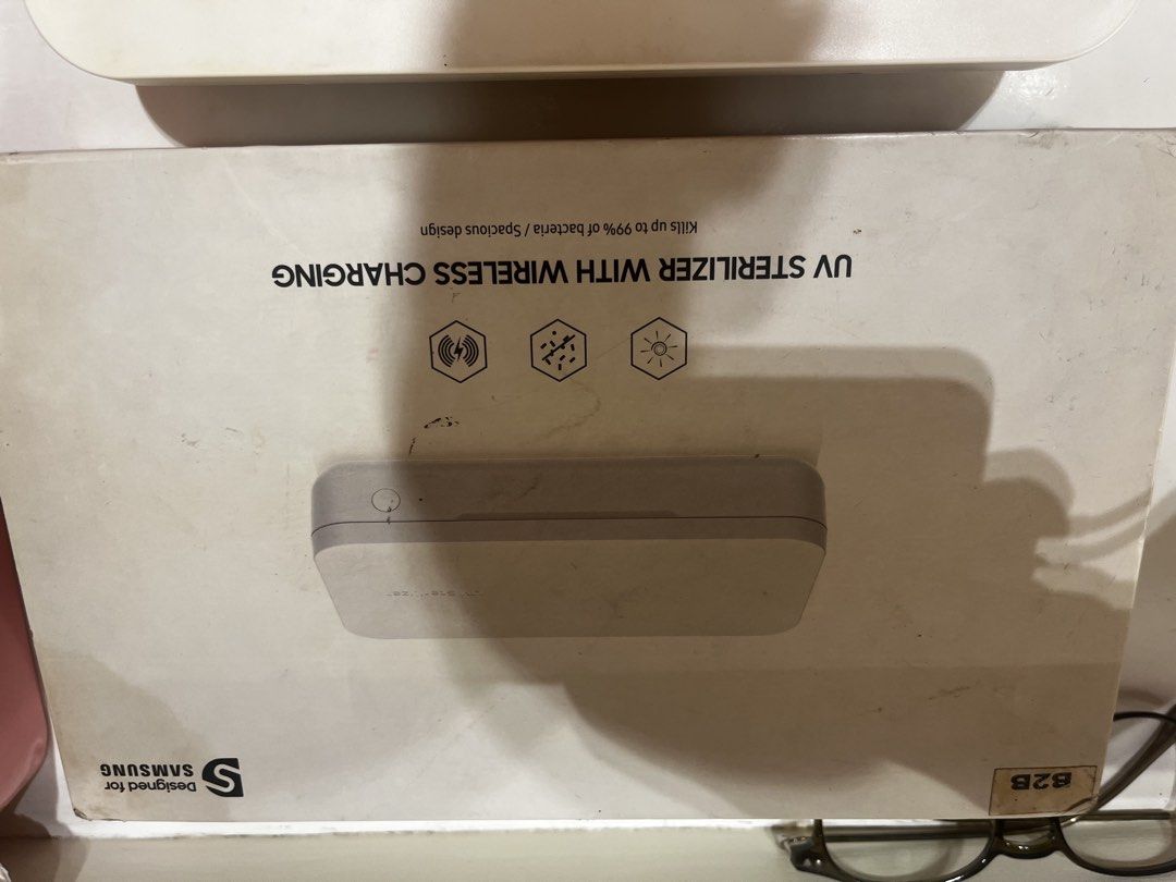 Samsung UV Sterilizer with Wireless Charging (Category: Batteries & Power Banks) located in Mandaluyong City. Submitted by flowgie (Listing ID 1466401775, Image 2). Description: samsung UV STERILIZER WITH WIRELESS CHARGING , working unit , inclusions box lang and manual . lalamove pickup bagumbayan qc - Authentic Samsung UV sterilizer box in clean white - Safely sanitizes small daily essentials like smartphones, keys, and cards - Built-in wireles