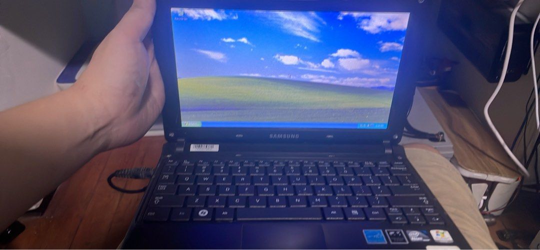 Vintage Samsung Windows XP Netbook (Category: Laptops & Notebooks) located in Manila. Submitted by modeltrainsph (Listing ID 1466442819, Image 2). Description: - Model: Vintage Samsung N150plus Netbook in compact black chassis - OS: Runs on Windows XP, boots up and shuts down normally - Condition: Powers on fine via cable and battery, includes built-in keyboard and trackpad - Ideal For: Retro computing hobbyists and vintage tech collectors - Incl