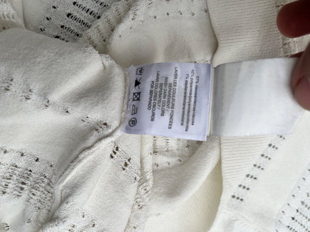 Sandro Paris White Short Sleeve Knit Top (Category: Blouses) located in Bacoor. Submitted by 4103archivalgarmentph (Listing ID 1466529071, Image 2). Description: - Brand: Sandro Paris - Color: White with open knit striped pattern - Size: 1 (Sandro sizing) - Material: 57% viscose, 42% polyamide, 1% elastane - Design: Short sleeves with a classic crew neckline - Condition: Lightweight, breathable, and great for layering or wearing solo -knitted -18
