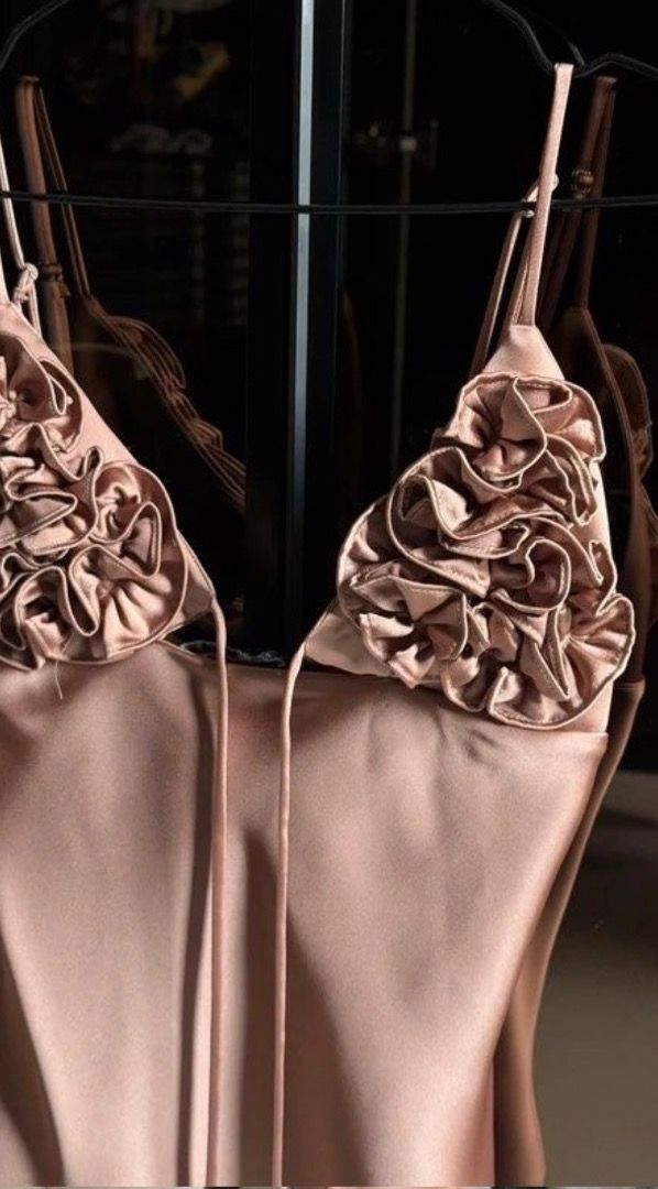 Satin Cami Top with Rosette Detailing Rose Gold (Category: Sleeveless) located in Caloocan City. Submitted by zaramndz (Listing ID 1466404270, Image 2). Description: - Color: Rose Gold - Material: Smooth, silky fabric with a slight sheen - Details: Thin spaghetti straps and front tie strings.