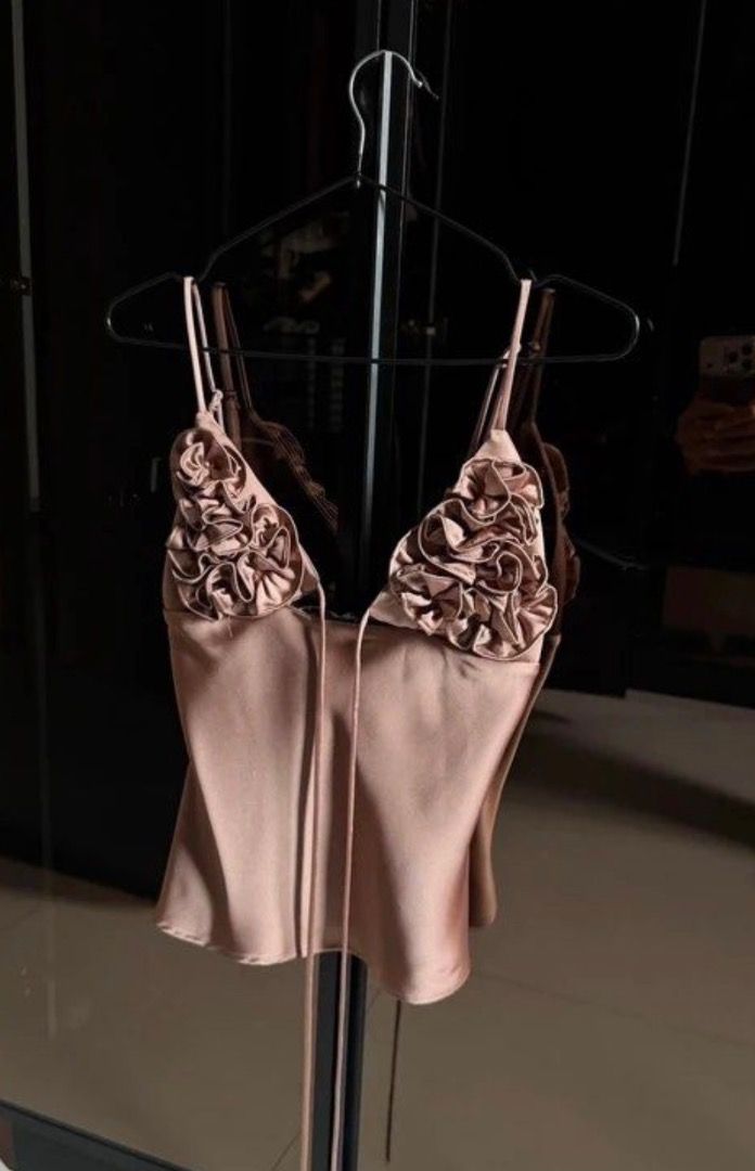 Satin Cami Top with Rosette Detailing Rose Gold (Category: Sleeveless) located in Caloocan City. Submitted by zaramndz (Listing ID 1466404270, Image 1). Description: - Color: Rose Gold - Material: Smooth, silky fabric with a slight sheen - Details: Thin spaghetti straps and front tie strings.