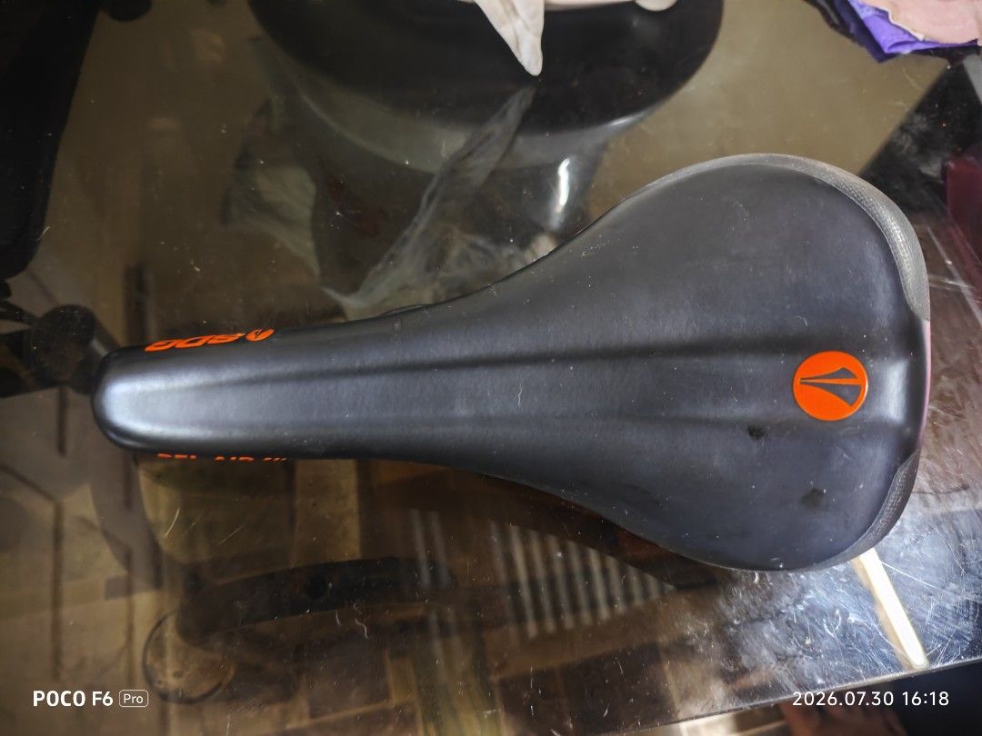 SDG saddle Bel-Air 3.0 (Category: Bicycles) located in Manila. Submitted by eseblud (Listing ID 1466506173, Image 1). Description: - Model: SDG Bel-Air III bike saddle - Design: Sleek black top cover with vibrant orange accents and branding - Build: Durable black steel rails and sturdy orange base shell - Compatibility: Standard mountain bike and trail setups - Condition: Excellent, comfortable upgrade for your ride.