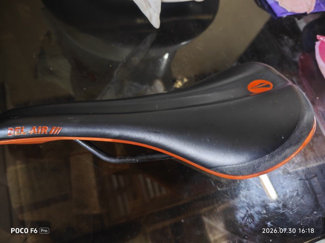 SDG saddle Bel-Air 3.0 (Category: Bicycles) located in Manila. Submitted by eseblud (Listing ID 1466506173, Image 3). Description: - Model: SDG Bel-Air III bike saddle - Design: Sleek black top cover with vibrant orange accents and branding - Build: Durable black steel rails and sturdy orange base shell - Compatibility: Standard mountain bike and trail setups - Condition: Excellent, comfortable upgrade for your ride.
