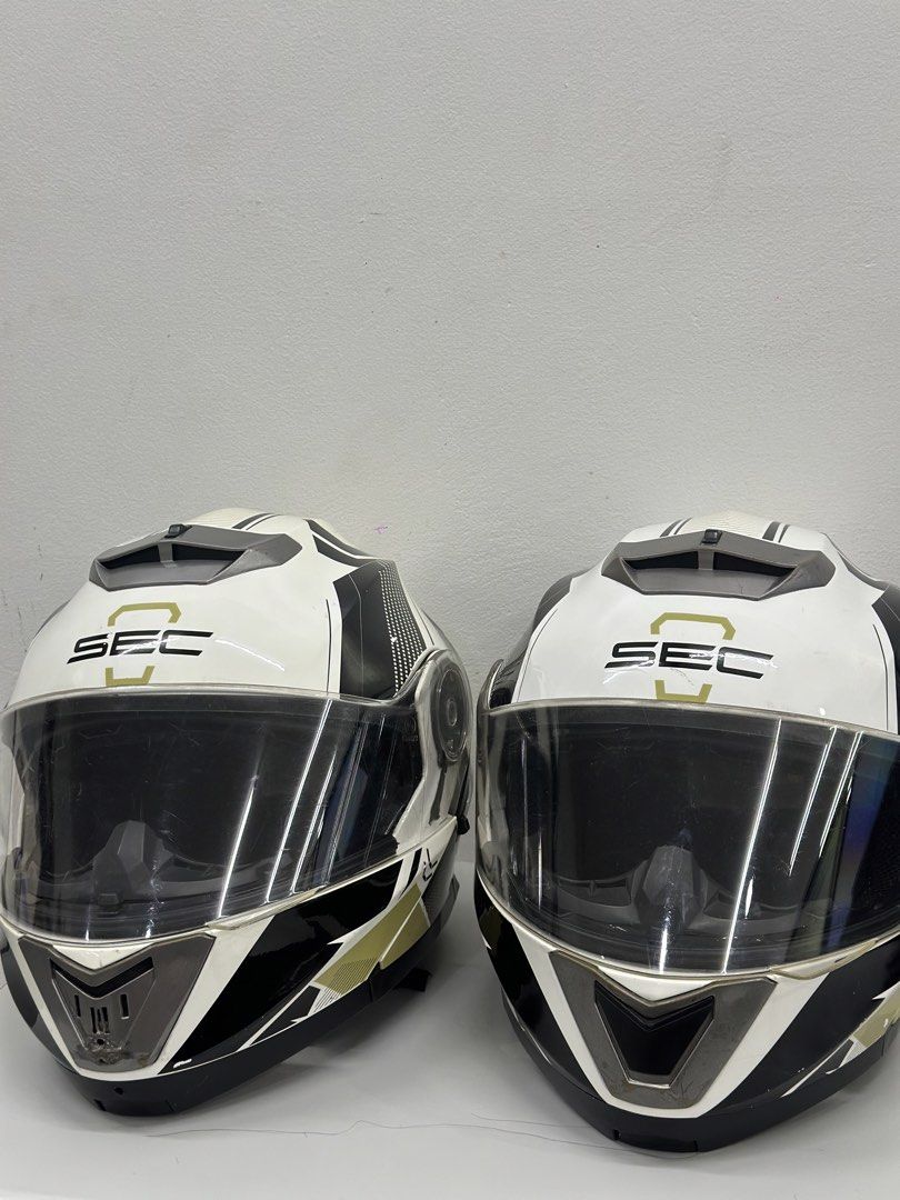 SEC Motorcycle Helmet - Phantom Race (Category: Bicycles) located in Manila. Submitted by cnmanaois19234 (Listing ID 1466563038, Image 1). Description: - Brand: SEC Motorcycle Helmet - Color/Design: White, black, and gold graphics - Type: Full face coverage with clear visor and retractable inner sun shield - Comfort & Fit: Clean, intact interior padding with adjustable strap and quick-release buckle - Ventilation: Top and front ventilation vents 