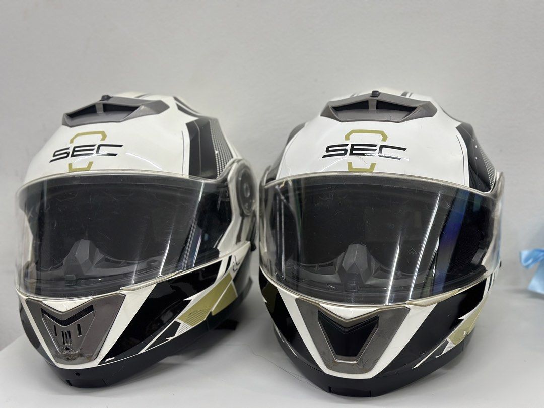 SEC Motorcycle Helmet - Phantom Race (Category: Bicycles) located in Manila. Submitted by cnmanaois19234 (Listing ID 1466563038, Image 2). Description: - Brand: SEC Motorcycle Helmet - Color/Design: White, black, and gold graphics - Type: Full face coverage with clear visor and retractable inner sun shield - Comfort & Fit: Clean, intact interior padding with adjustable strap and quick-release buckle - Ventilation: Top and front ventilation vents 